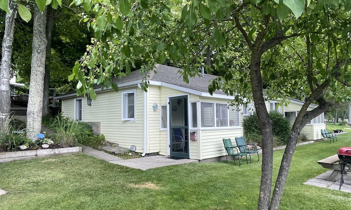Ludington Cottage | Cottage 1 is a charming 2 bedroom only 25’ from its boat dock & Hamlin lake.