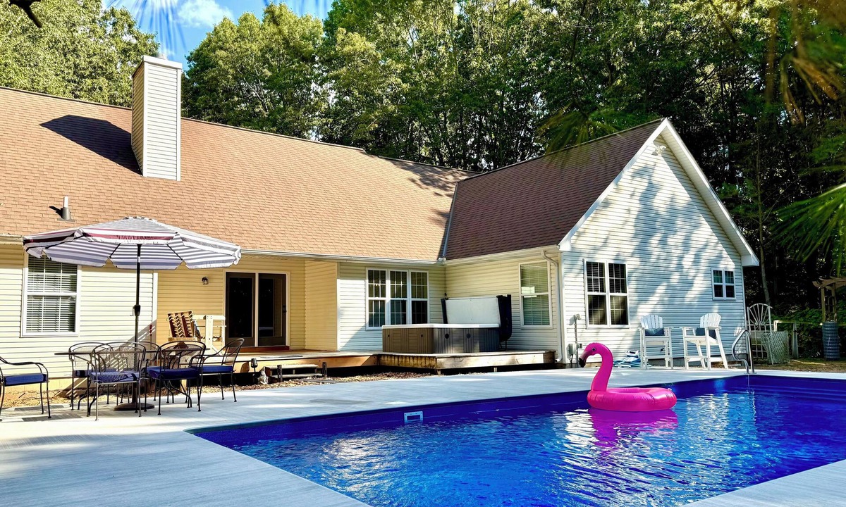 Fennville House | Upscale Wooded Retreat: Heated Pool, Hot tub, Fenced Yard & Game Room.
