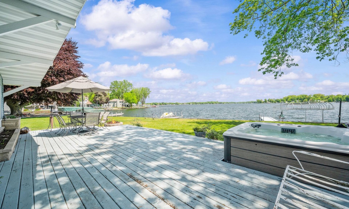 Paw Paw Lake House | Wake up to sunrise views over Paw Paw Lake at this cozy lakefront cottage with a dock, hot tub, and room for 8.