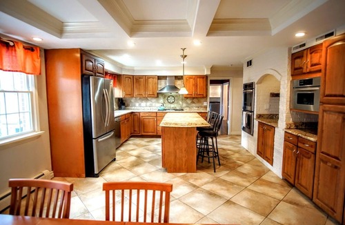 Stevensville House | Colonial style 5BR/5BA home tucked in a private, wooded setting w/pool & hot tub