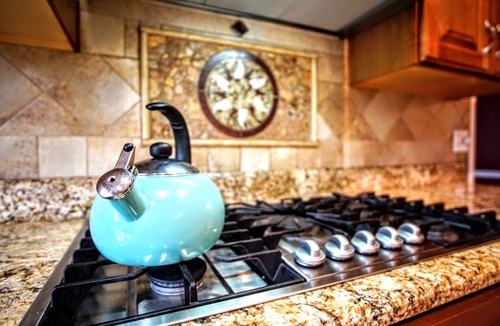 Stevensville House | Colonial style 5BR/5BA home tucked in a private, wooded setting w/pool & hot tub