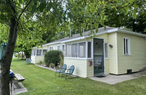 Ludington Cottage | Cottage 1 is a charming 2 bedroom only 25’ from its boat dock & Hamlin lake.