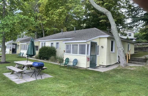 Ludington Cottage | Cottage 3 is a charming 2 bedroom 25’ from your boat dock & Hamlin lake.