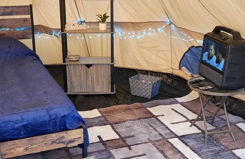 Mio RV Rental | Cozy Bell Tent Glamping on Private Fenced Deck with Bathhouse Firepit WiFi and Trails in Mio, Michigan