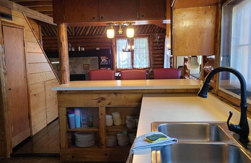 Gaylord Cabin | Cozy log cabin on quiet lake. Games, kayaks, and more for all-season fun.