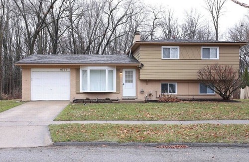 Commerce Township House | Cozy spacious 4-bedroom home nestled in wooded lot with enclosed porch