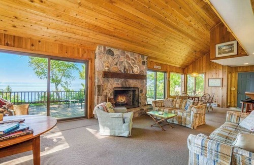 Lake Township House | Rustic dream-home w/lake views, wraparound deck, & wood-burning fireplace