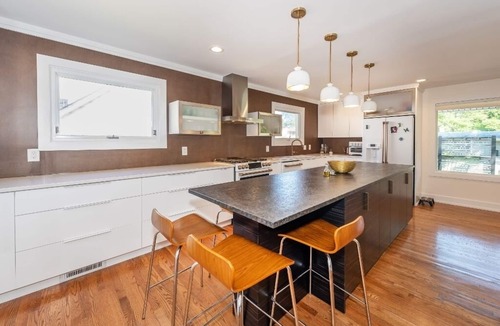 Dicken House | Walk to the Big House from this Stylish Home.