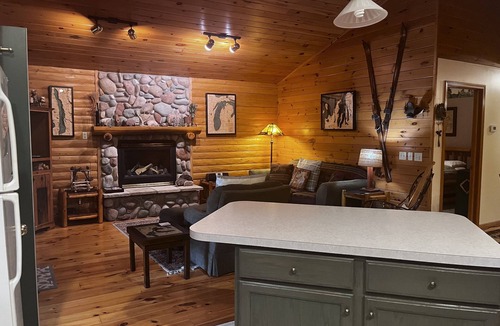 Bellaire House | Waterfront log home on Lake Bellaire. Pet friendly. Fireplace, dock. Dog ok