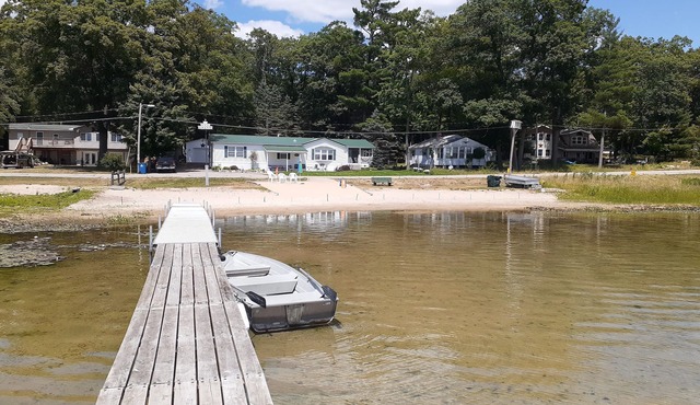 Beachfront retreat on beautiful Tallman lake near HuronManistee National Forest.
