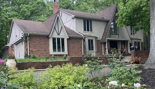 Beautiful English Farmhouse Tudor, situated on a lush hillside acre.