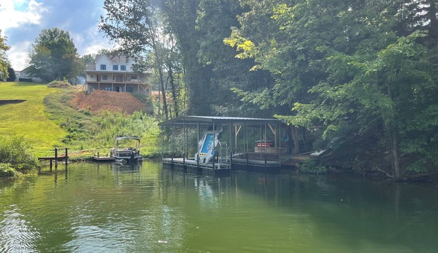 Lakefront home with dock. Cozy 2 bed 2 bath and screened in porch.