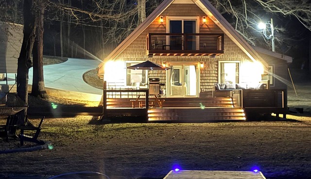 Peaceful lake house retreat with hot tub, dock, and fire pit.