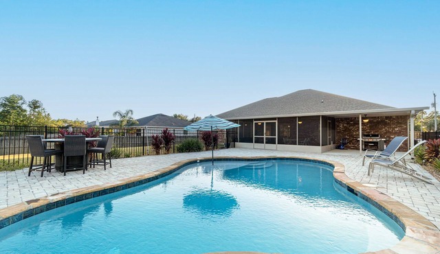 Single-level home with pool, enclosed yard, screened lanai, grill & home office