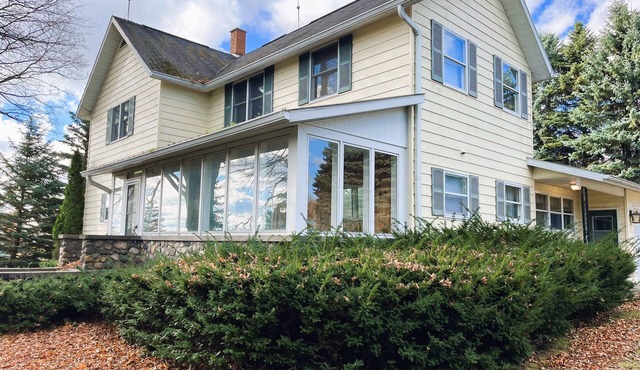 Suttons Bay farmhouse-style home. Five bedrooms. Air conditioning. Dog okay