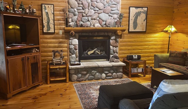 Waterfront log home on Lake Bellaire. Pet friendly. Fireplace, dock. Dog ok